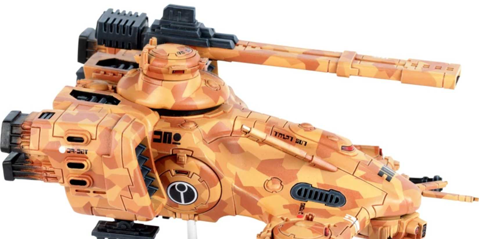 a hammerhead grav-tank painted in t'au sept colors has a rail gun mounted on its main turret in warhammer 40k.