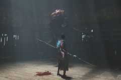 A player in Wuchang: Fallen Feathers fighting a boss.