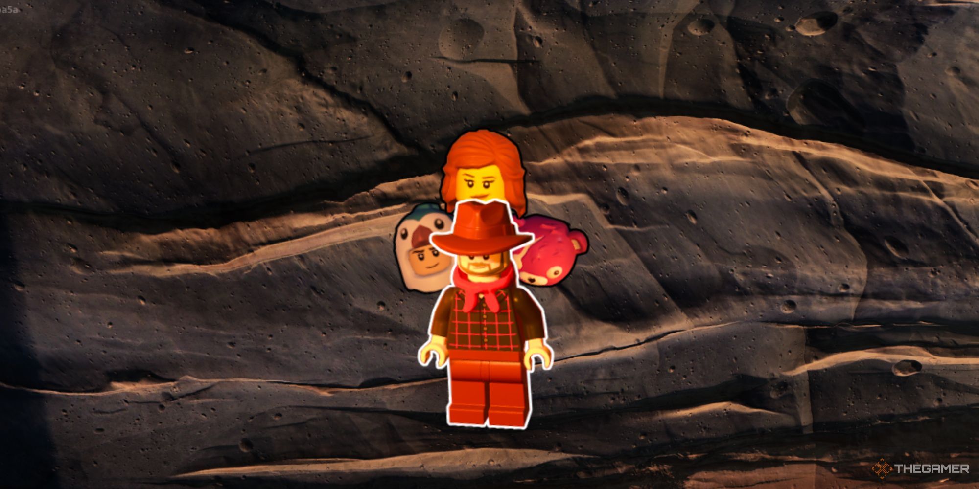 A cowboy with a red scarf and a white outline, with three lego heads behind him, and a rock wall as the background.