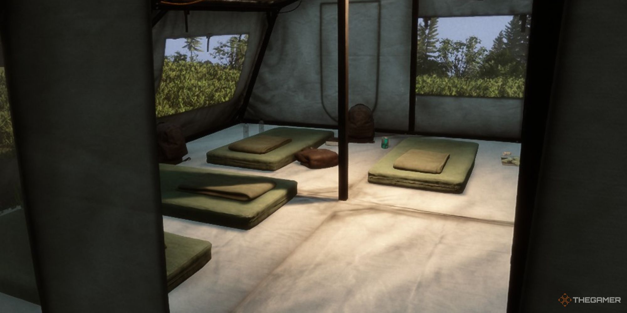 A screenshot from Sons of the Forest showing the interior of a large tent through a door, with a puffy red jacket being seen near a small green cot at the rear of the tent.