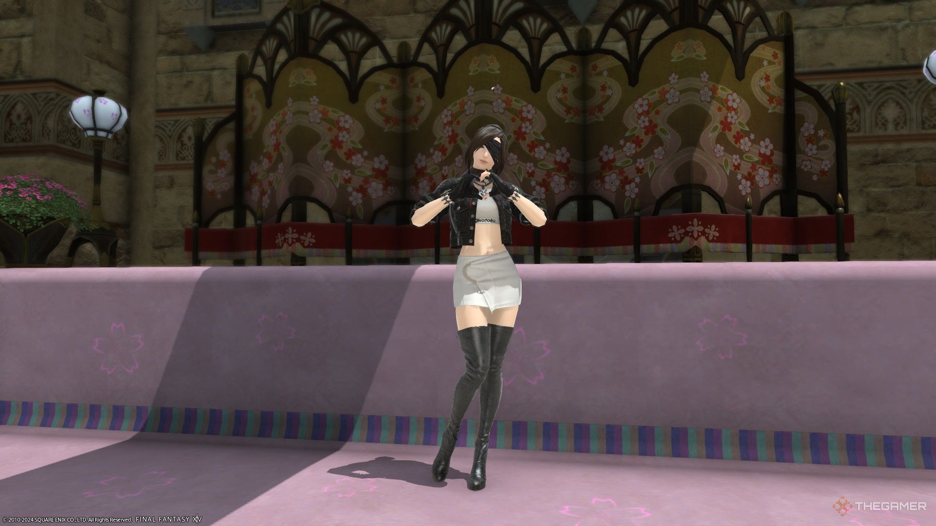 A player doing a heart emote in front of the Little Ladies' Day decorations in Final Fantasy 14.