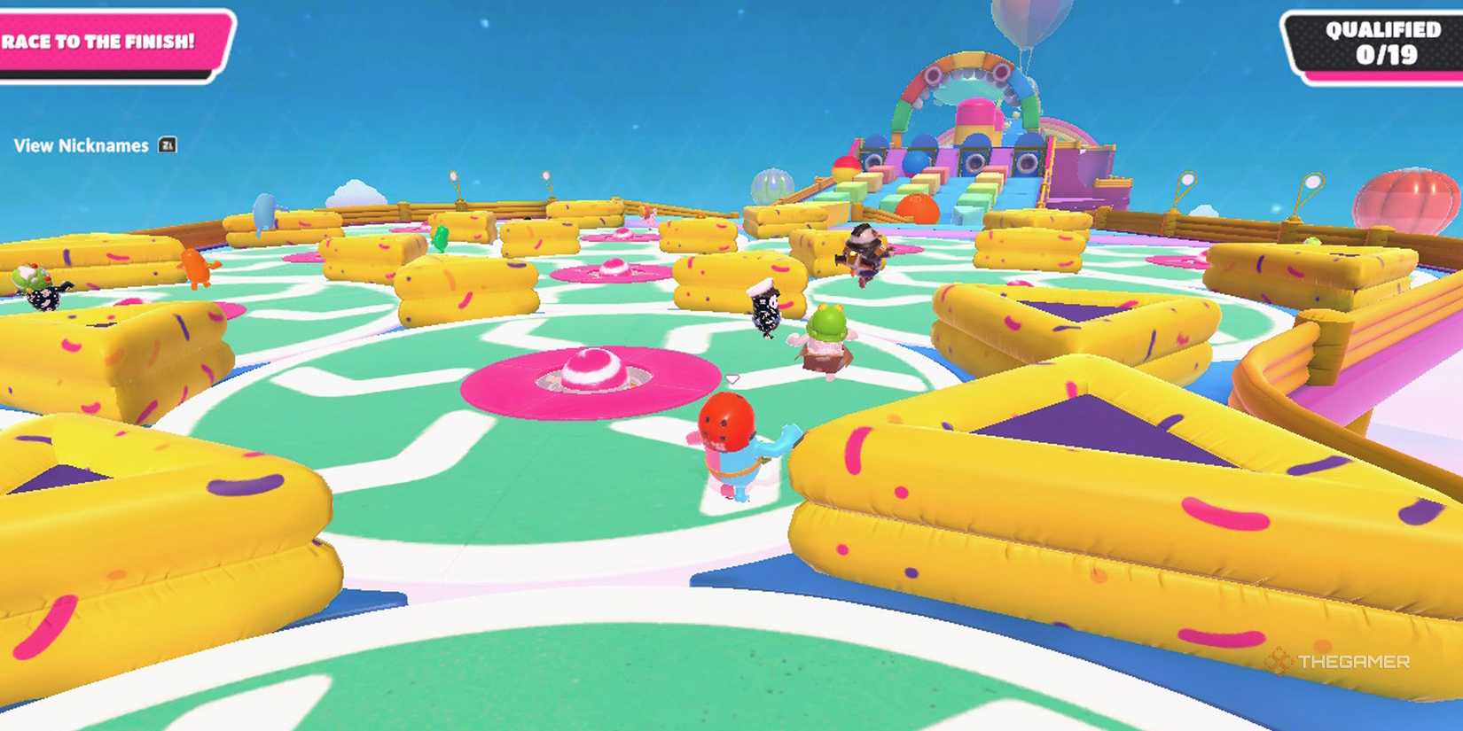 Jelly beans running on a rotating platform in Fall Guys.
