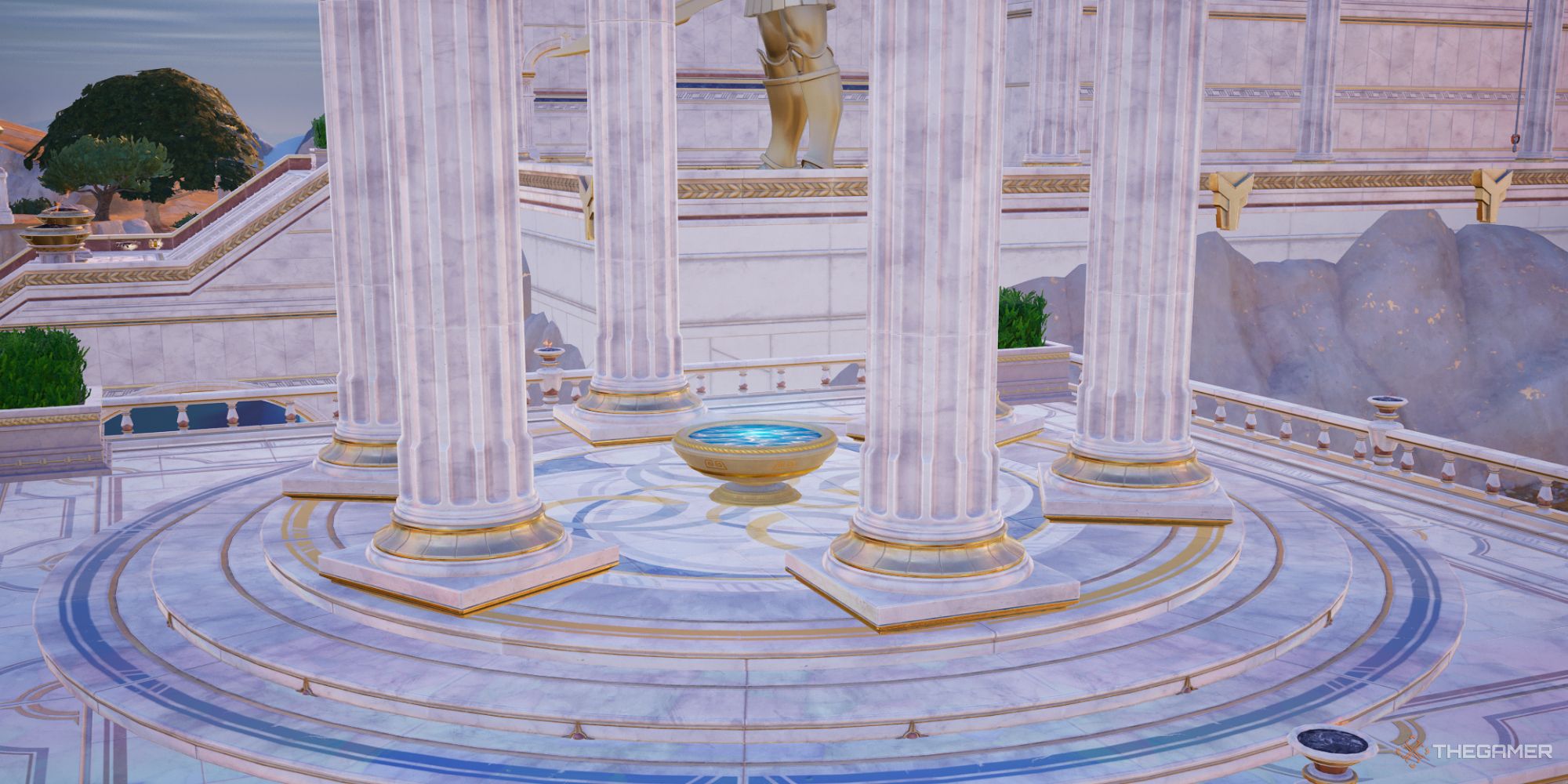 A screenshot from Fortnite Chapter Five Season Two showing the Scrying Pool at Mount Olympus surrounded by marble columns with a bronze statue and marble structure visible in the distance.