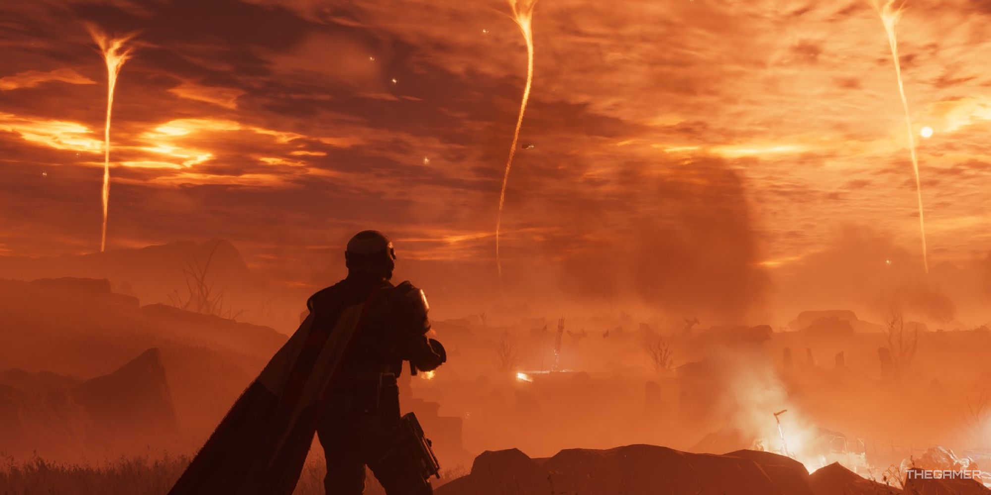 A screenshot ftom Helldivers 2 showing the player character standing on the edge of a cliff and looking into the distance to see three fire tornadoes in the distance.