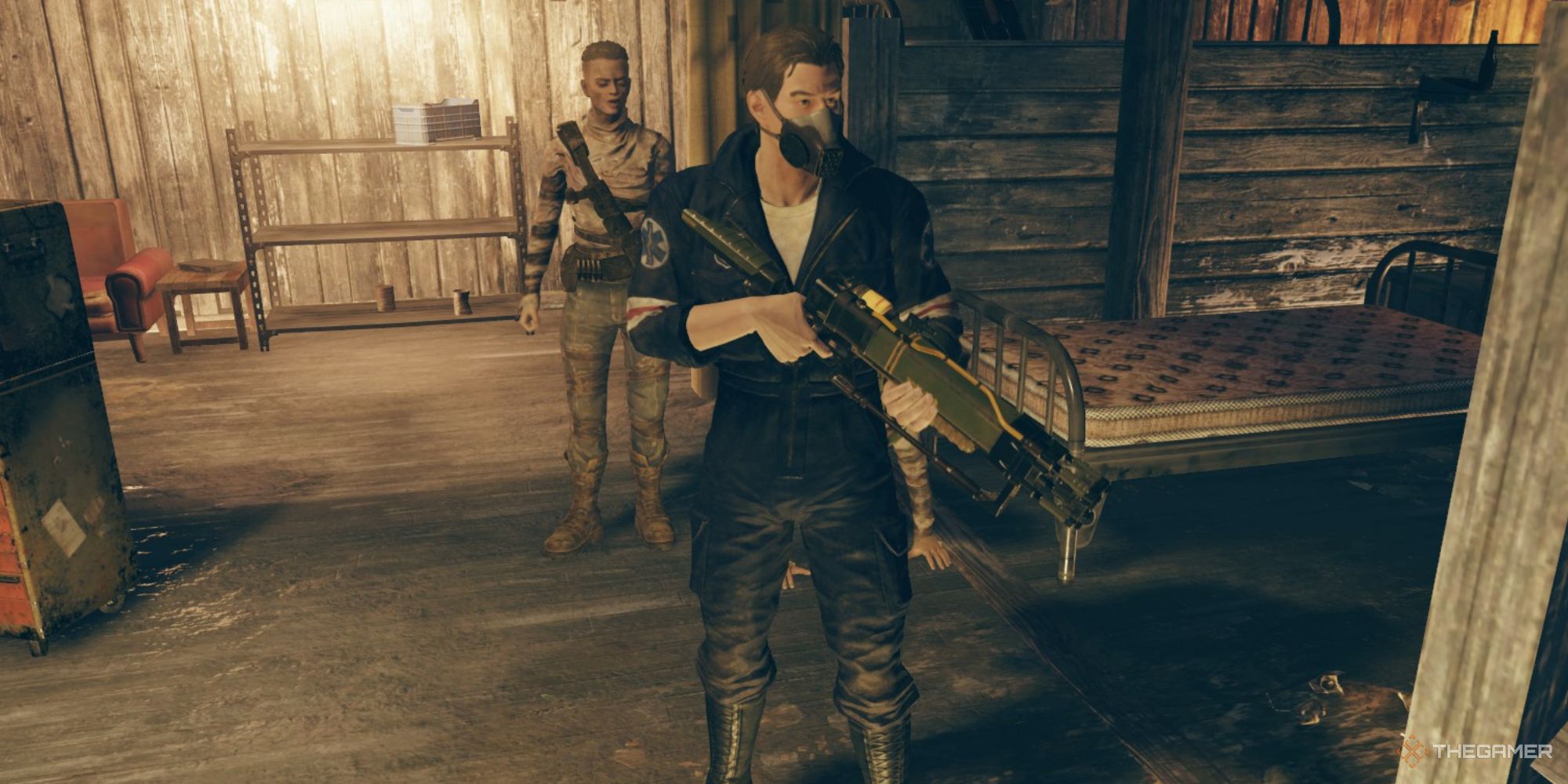 A screenshot from Fallout 76 showing the player character holding a long energy weapon in standby, with the gun pointing off to the side and toward the ground. The player character can be seen in a Responders jumpsuit and a gas mask.