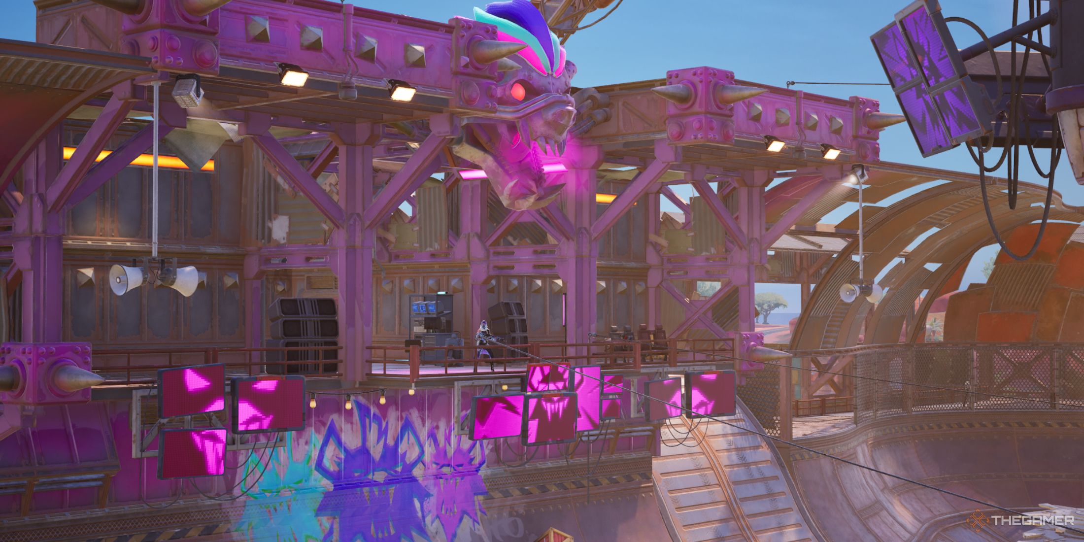 The Nitrodome's stage with pink paint across the metal structures and metallic wolf's face that has pink smoke coming out of the mouth. There are pink screens that connect to show a wolf's face under the stage.