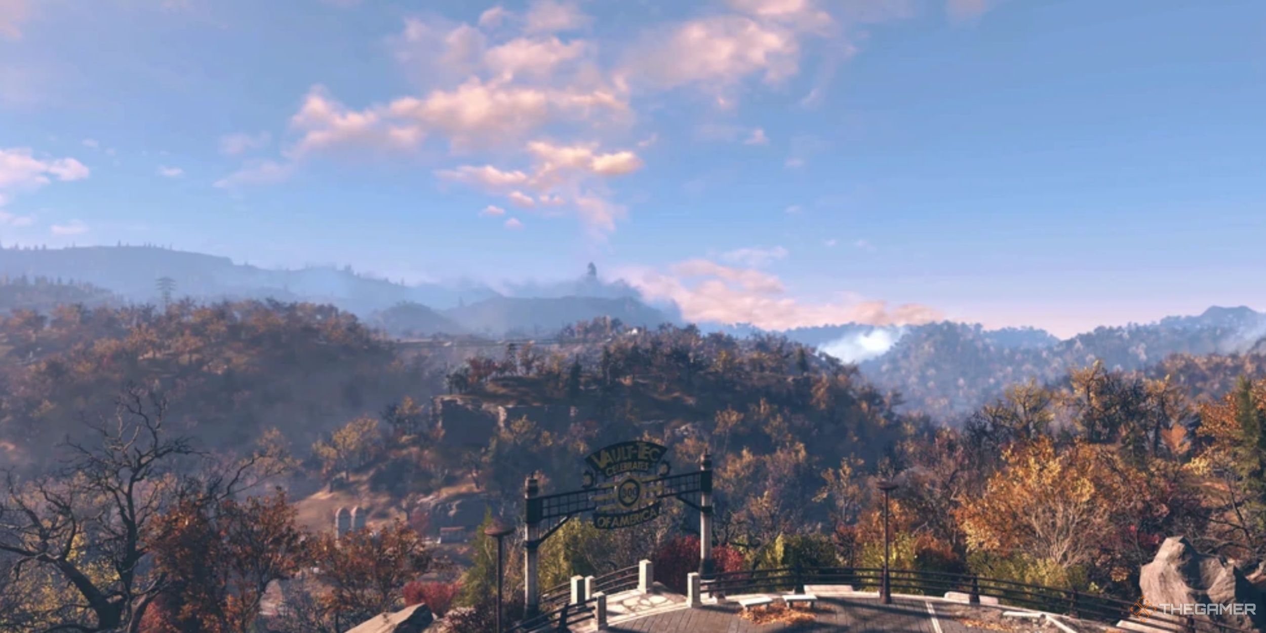 The forested landscape of Fallout 76 under a clear blue sky.