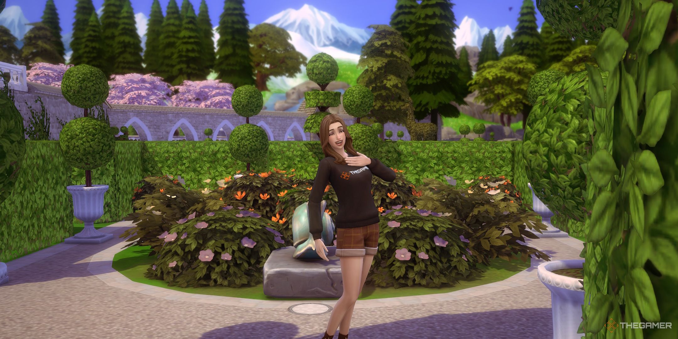 A female Sim poses by flowers a mountain for a screenshot