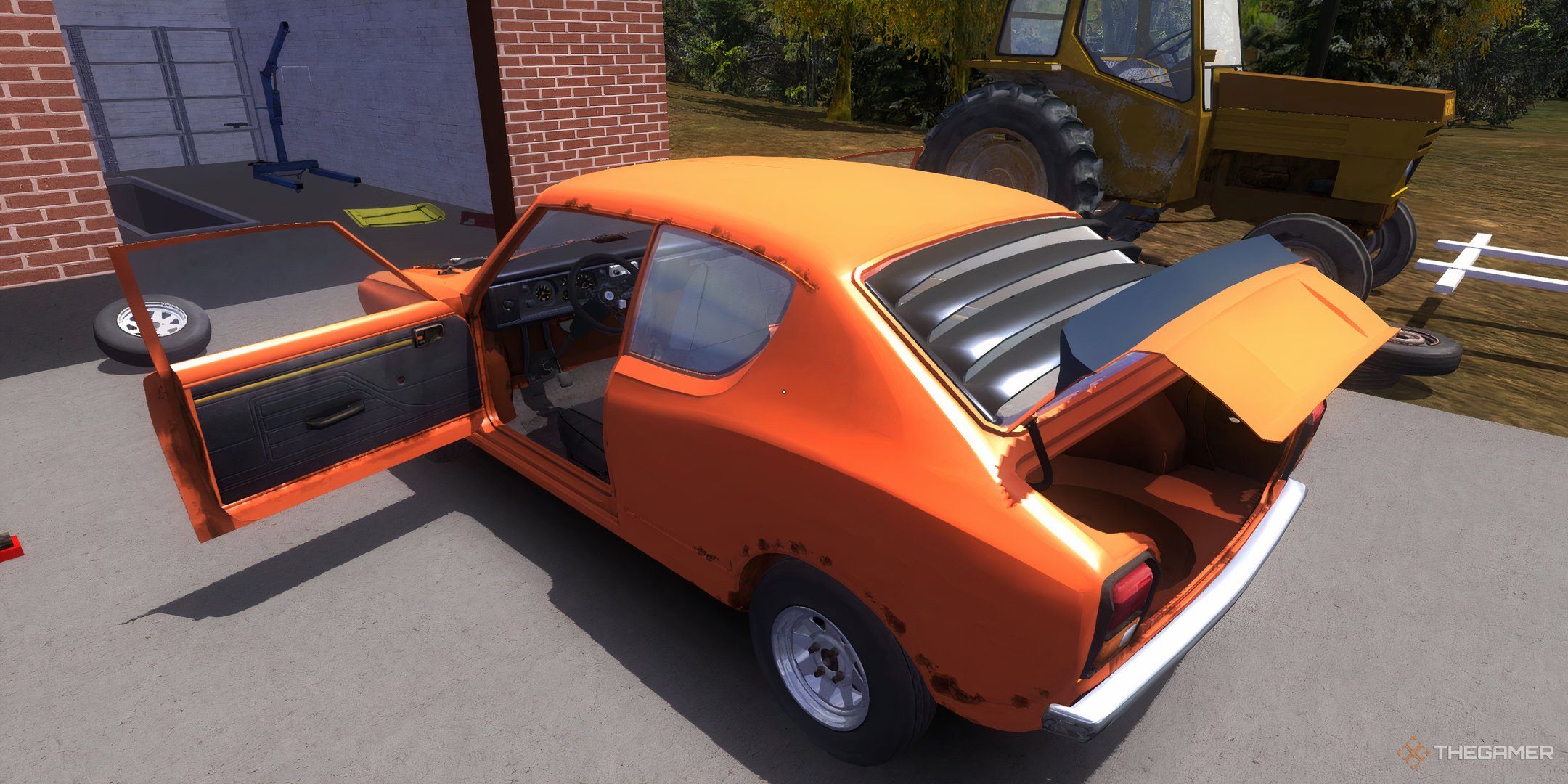 A parked, orange car with the trunk and driver side door open.