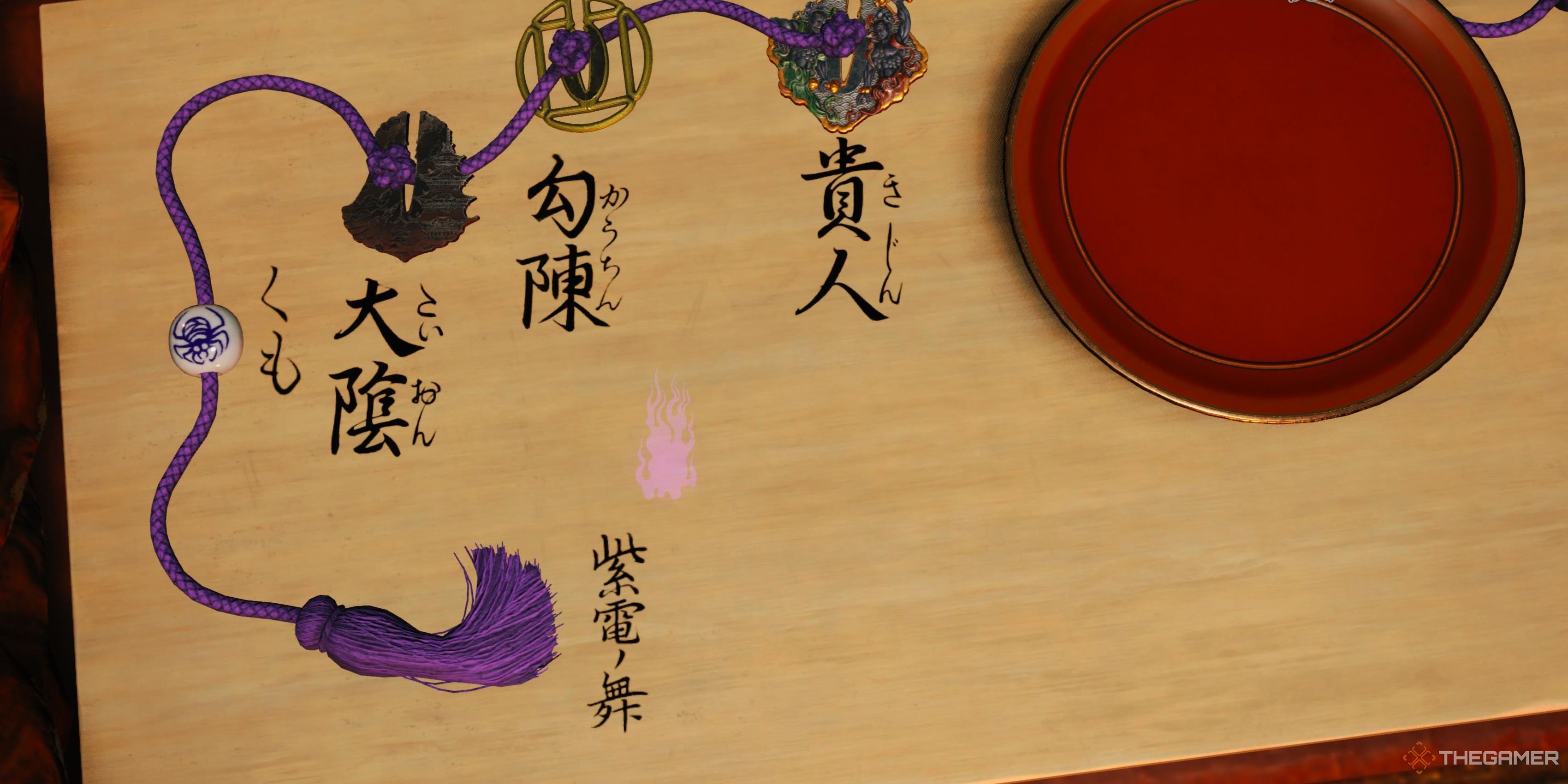 Multiple tsuba guards placed on a purple rope in Kunitsu-Gami path of the goddess