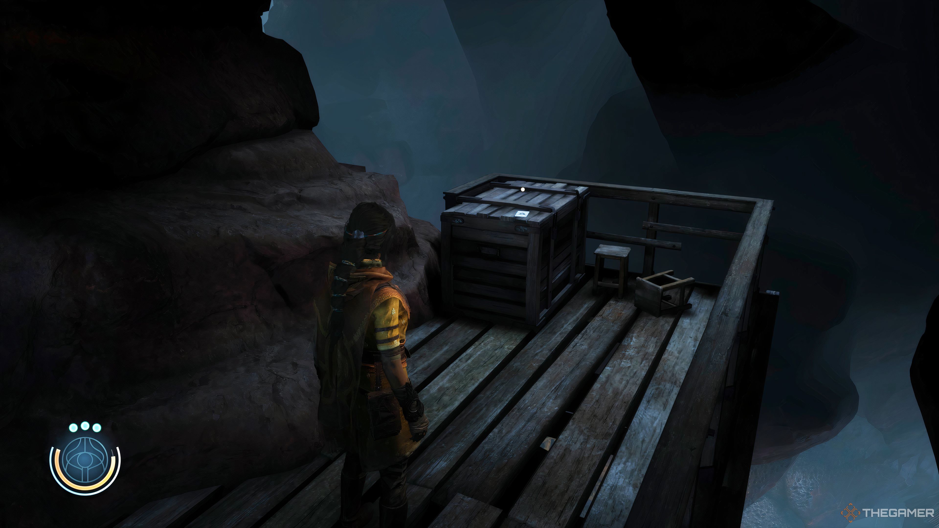 Haroona standing by an Ascension Card on a crate in Peshanden in Unknown 9: Awakening.