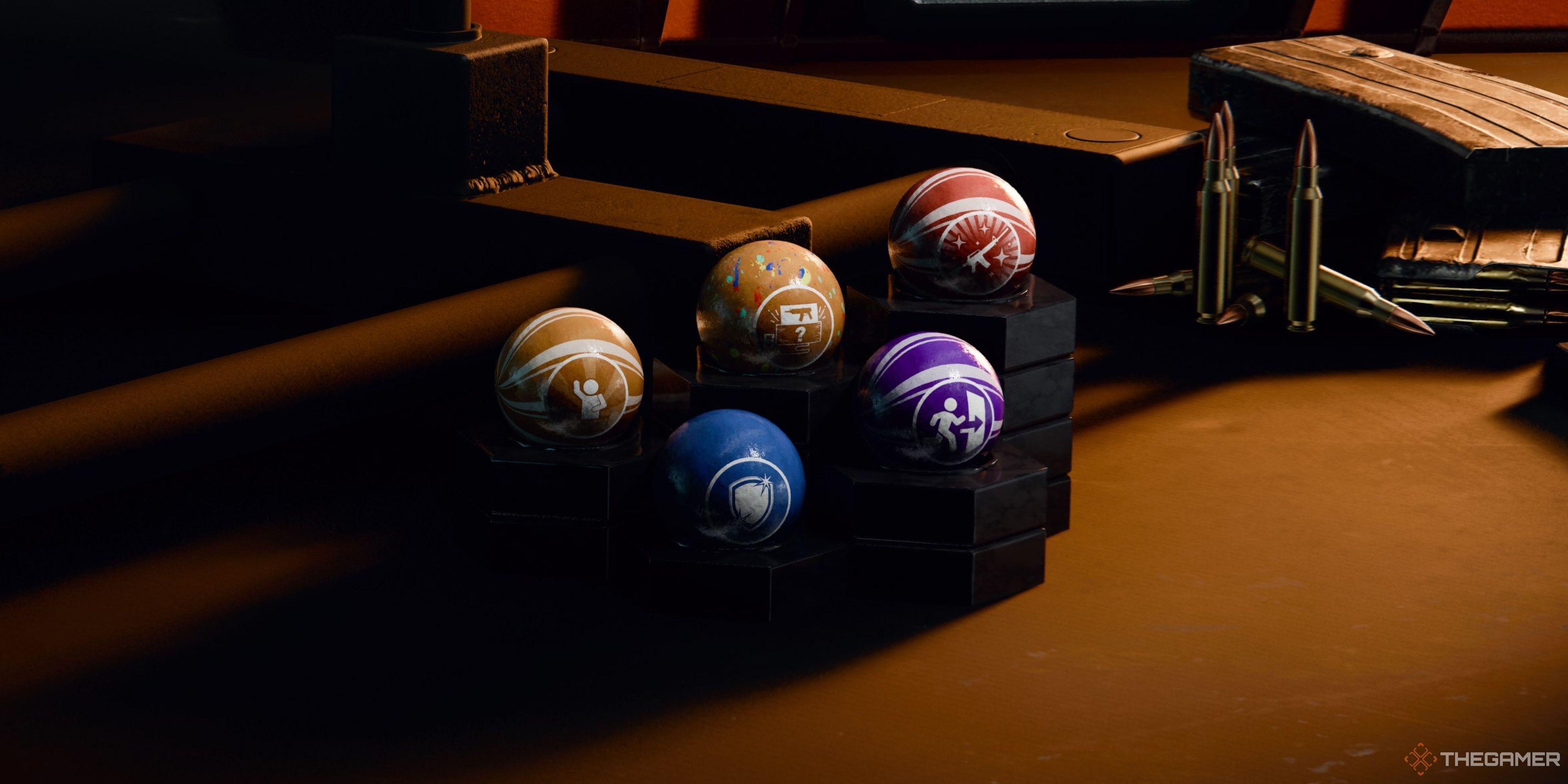 Black Ops 6 - Five Gobblegums stacked next to each other on a table near some loose ammo.