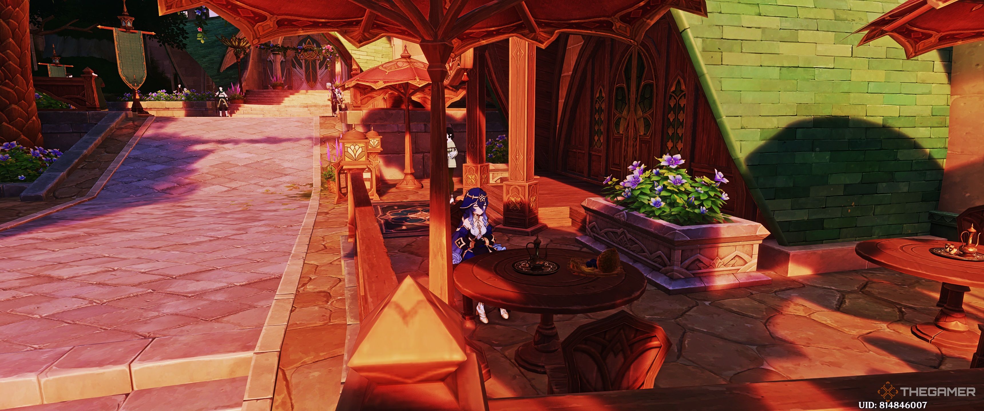 Layla sitting on a chair in a cafe in Sumeru in Genshin Impact.