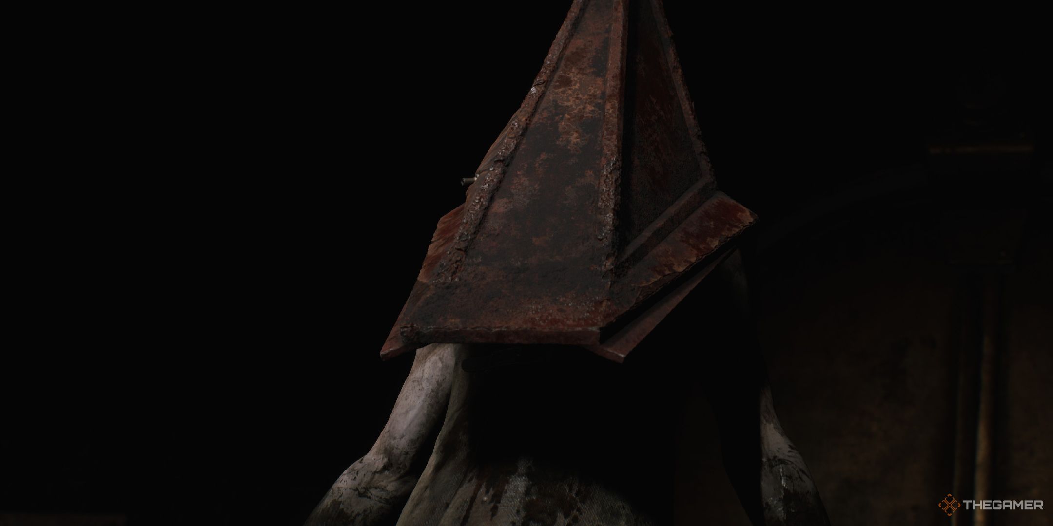 Silent Hill 2 Remake Pyramid Head standing in the dark in front of a doorway