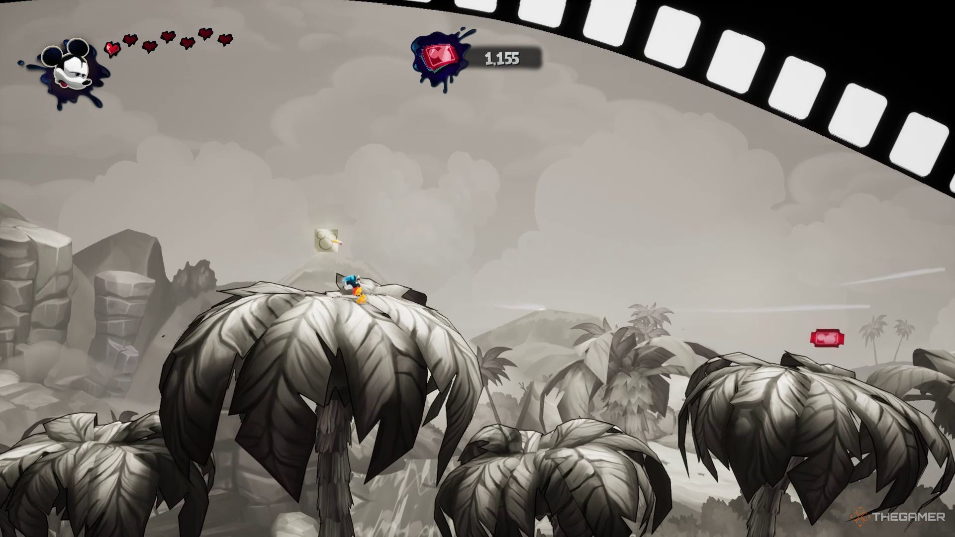 میکی در نزدیکی یک هنر مفهومی بر فراز یک درخت نخل بزرگ در Castaway قسمت دوم در Epic Mickey: Rebrushed.
