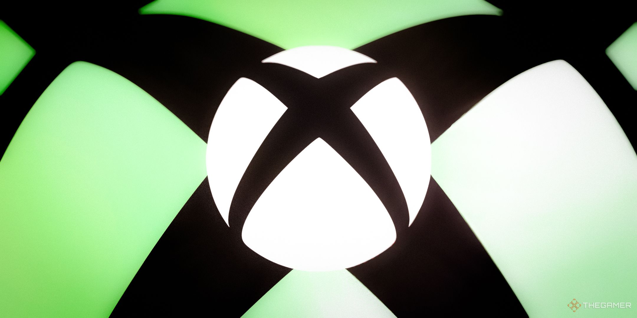 NEWS white Xbox logo over black background and larger green Xbox logo.