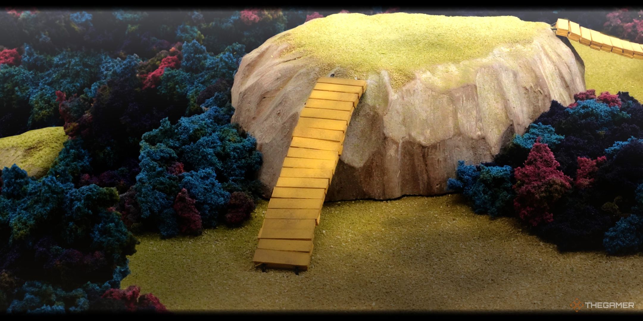 A hill with a bridge leading up to it in the Ancient Hill area.