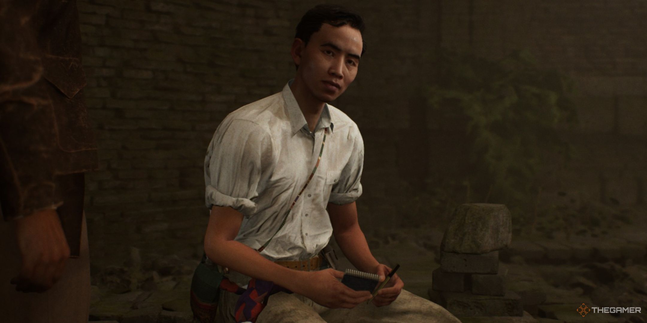 aran seated with a notebook in the khmer warrior temple in indiana jones and the great circle.