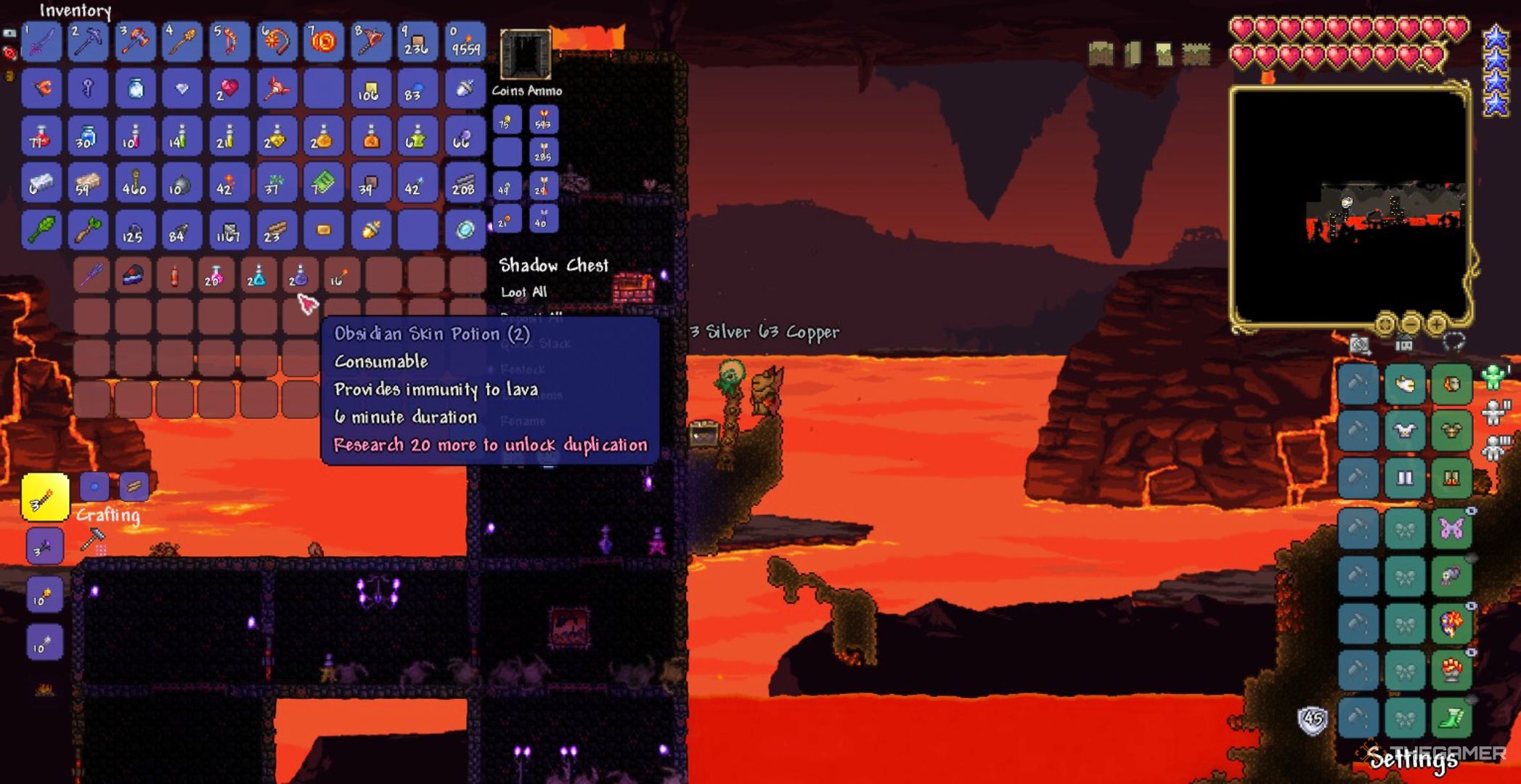 Player character in Journey Mode finding Obsidian Skin Potions in a Shadow Chest in Terraria.