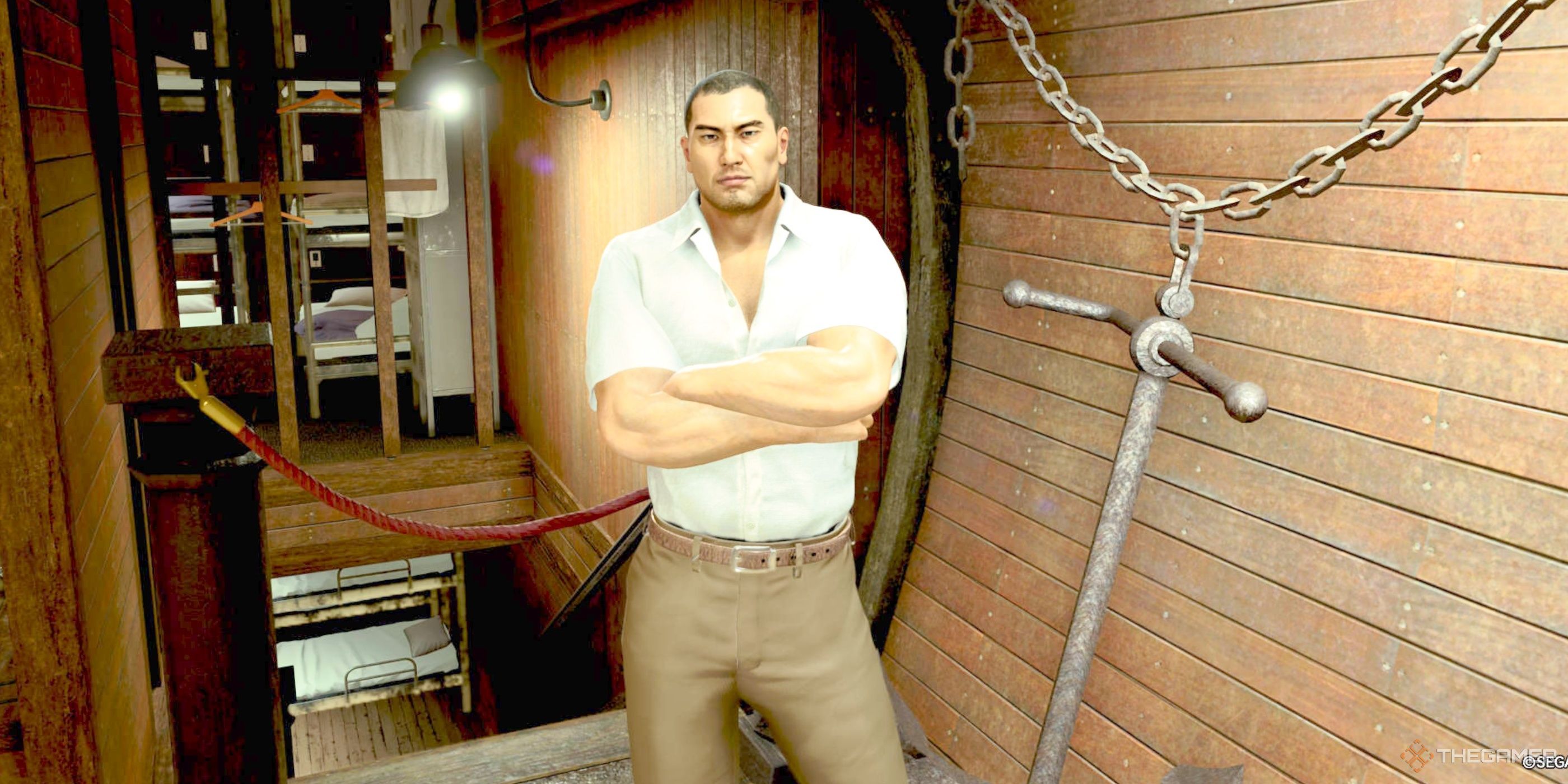 Taiga Saejima standing in the corner on the Goromaru lower deck in Like A Dragon: Pirate Yakuza In Hawaii.