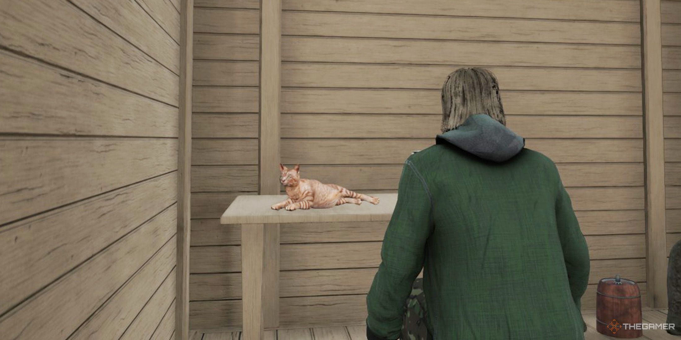 The player is looking at his cat which is laying on a wooden table in Ranch Simulator.