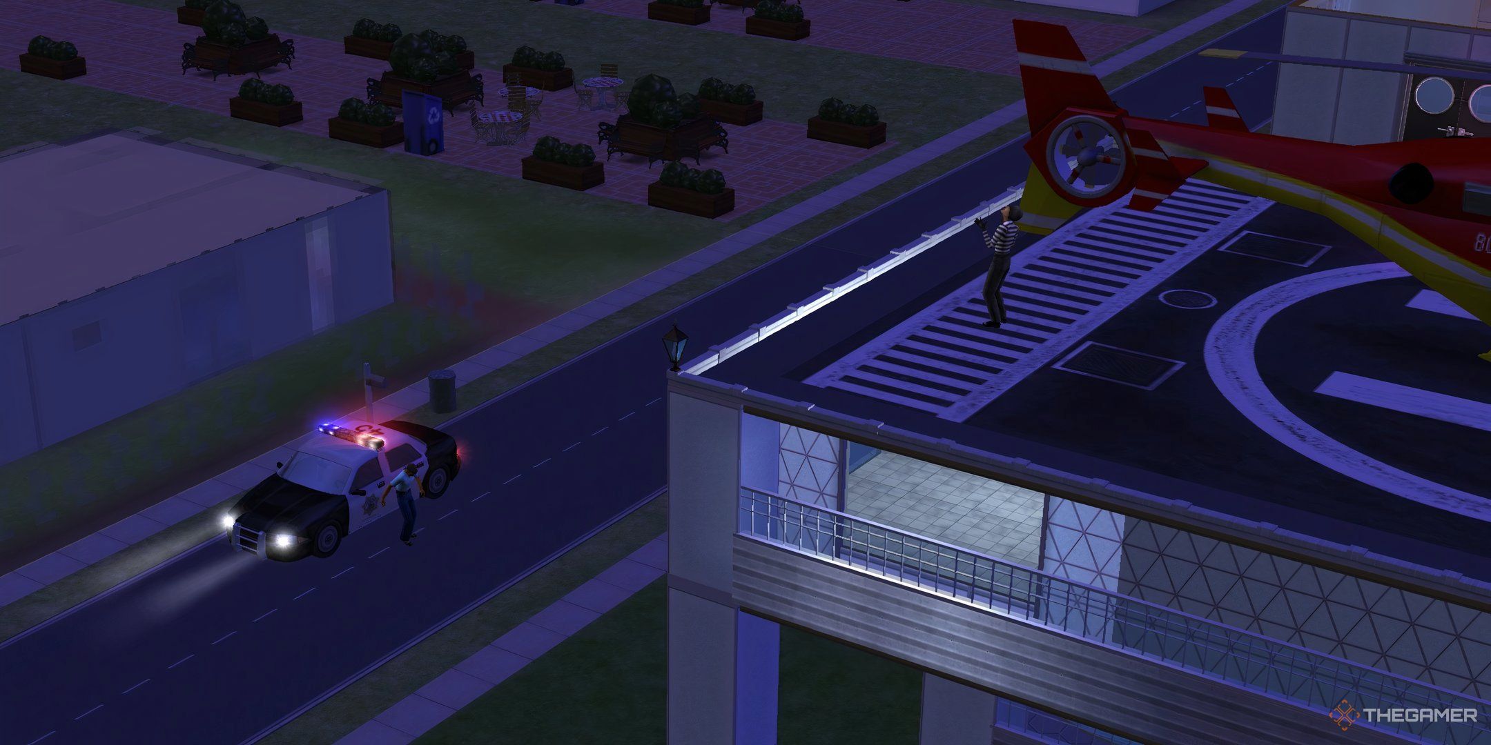 A burglar Sim stood on the roof by a helicopter in The Sims 2, overlooking a police Sim.