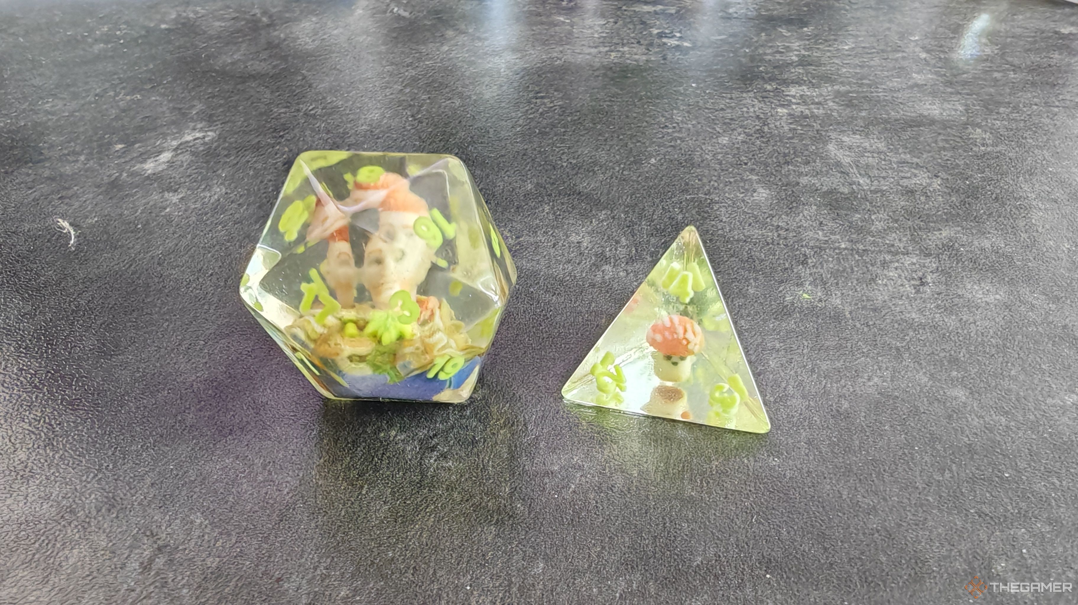 A d20 with a ranger character inside next to a d4 with a mushroom guy inside