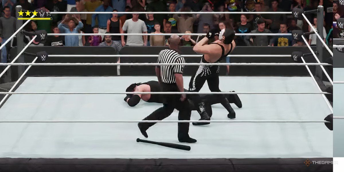 A gameplay screenshot of WWE 2K18, showing Sting yelling at the crowd while Undertaker lies prone on the ground.