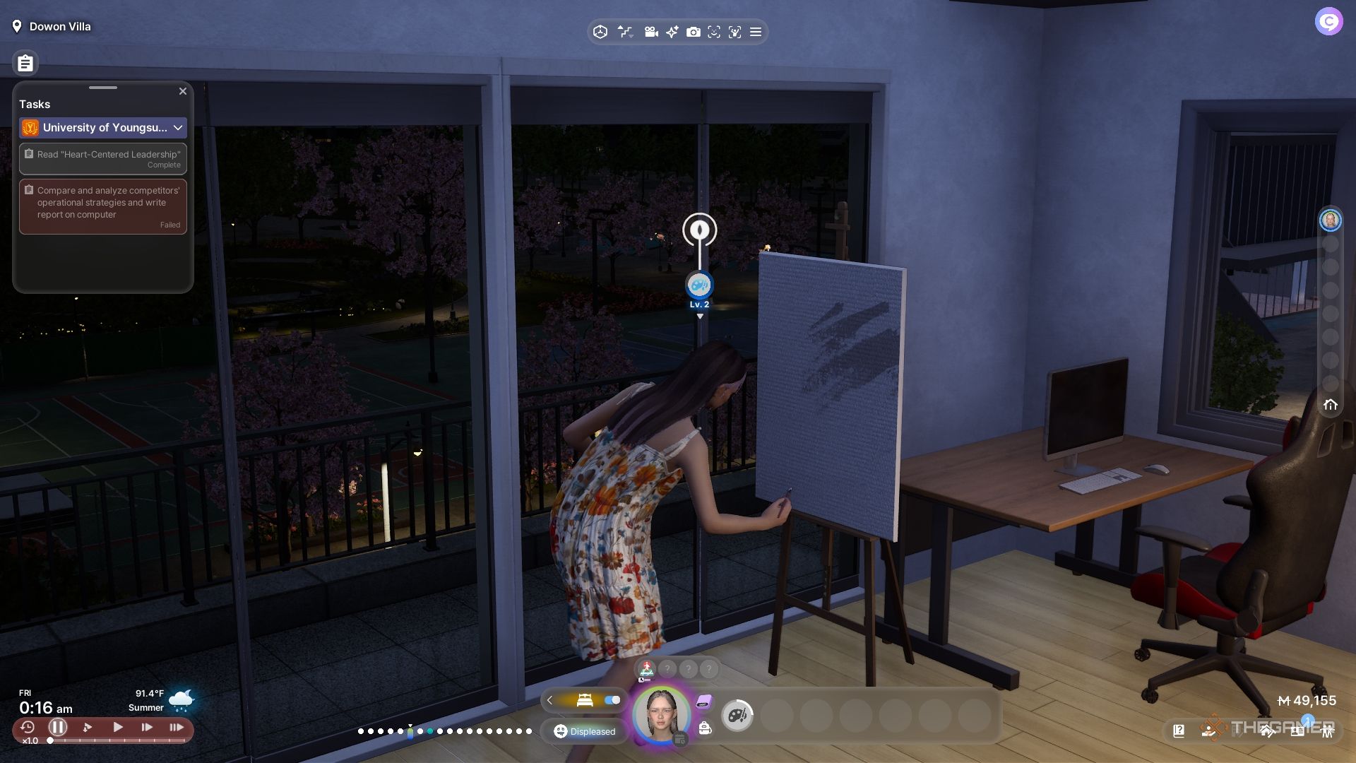 A woman painting at night in her apartment.