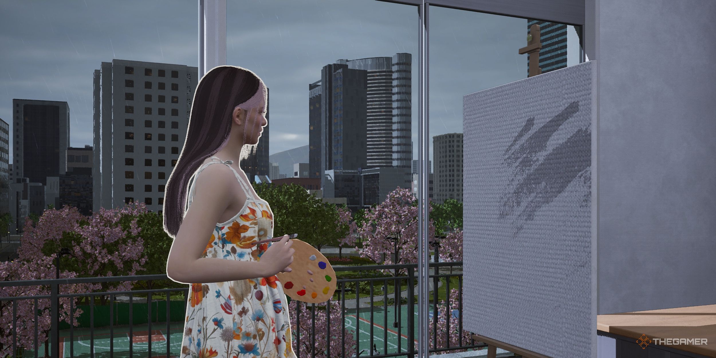 A woman painting by a sliding glass door while it rains outside.