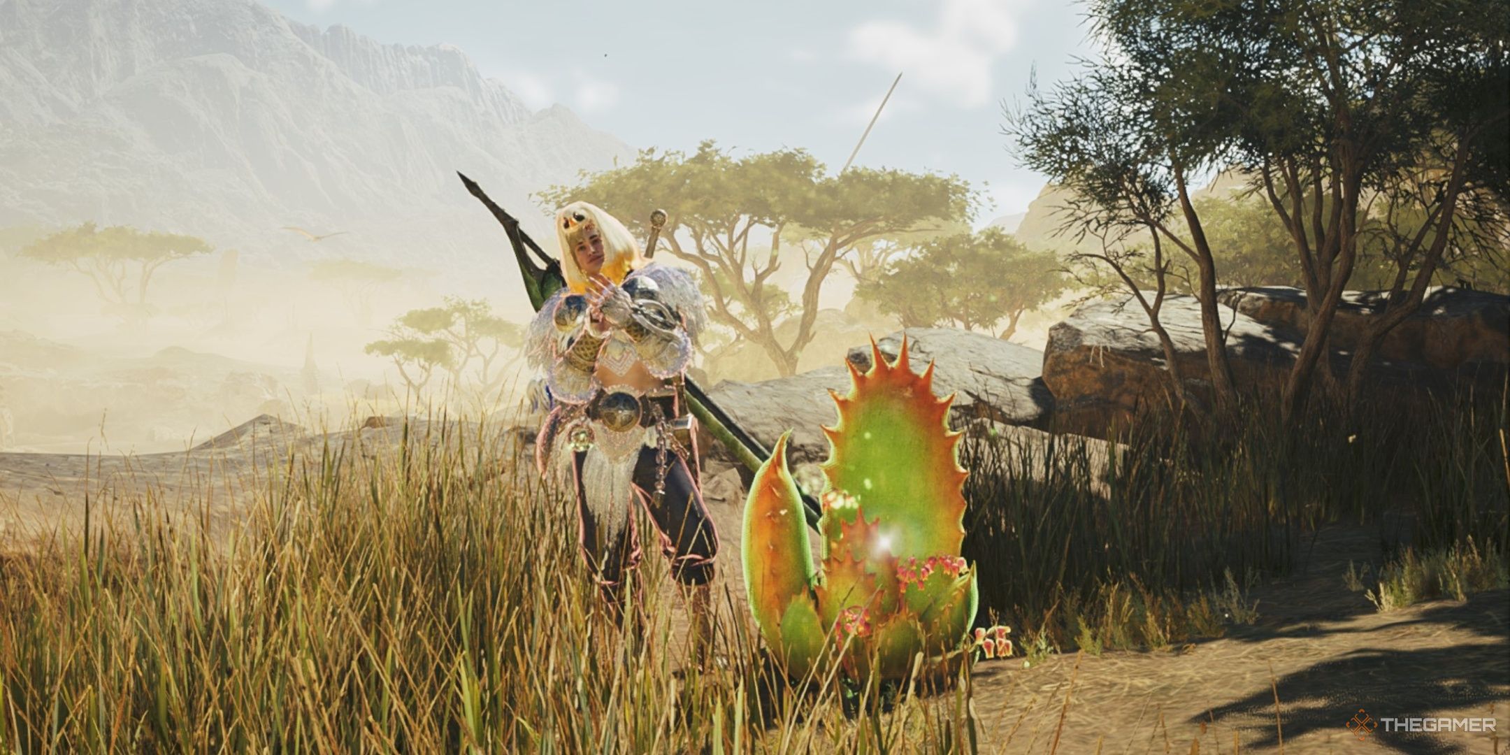 A hunter clapping beside a great windward aloe in monster hunter wilds.