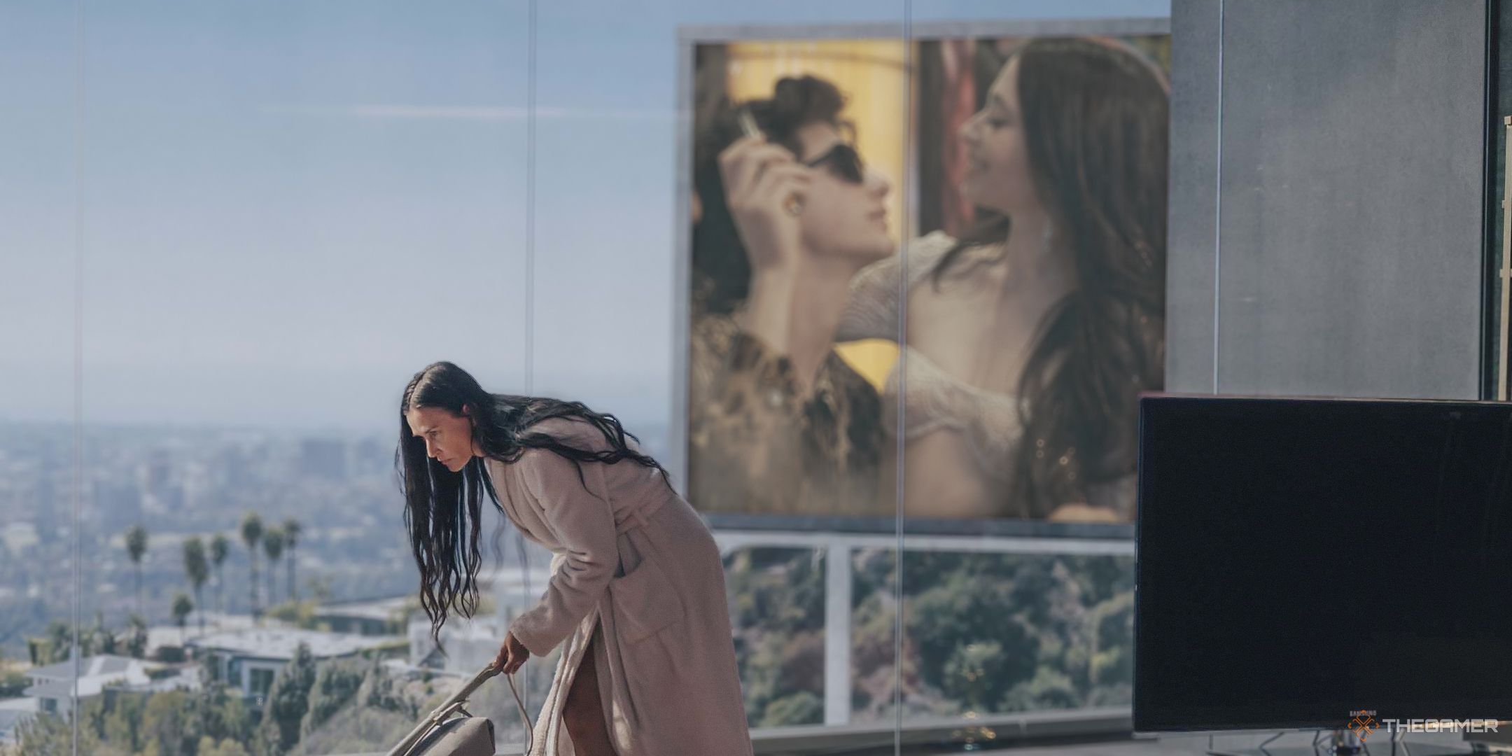 Demi Moore as Elisabeth Sparkle in her home with a billboard of Anora outside her window.