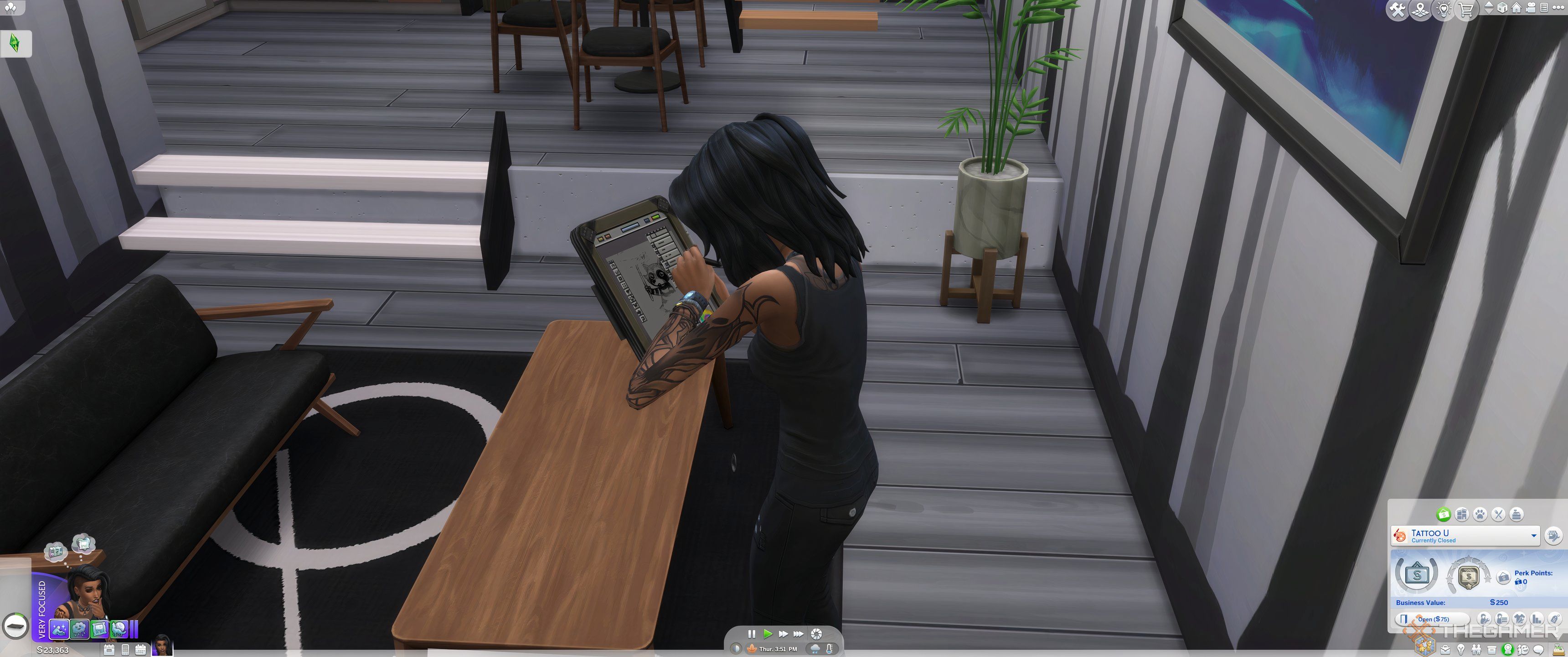 A female sim designing a tattoo on a sketchpad.
