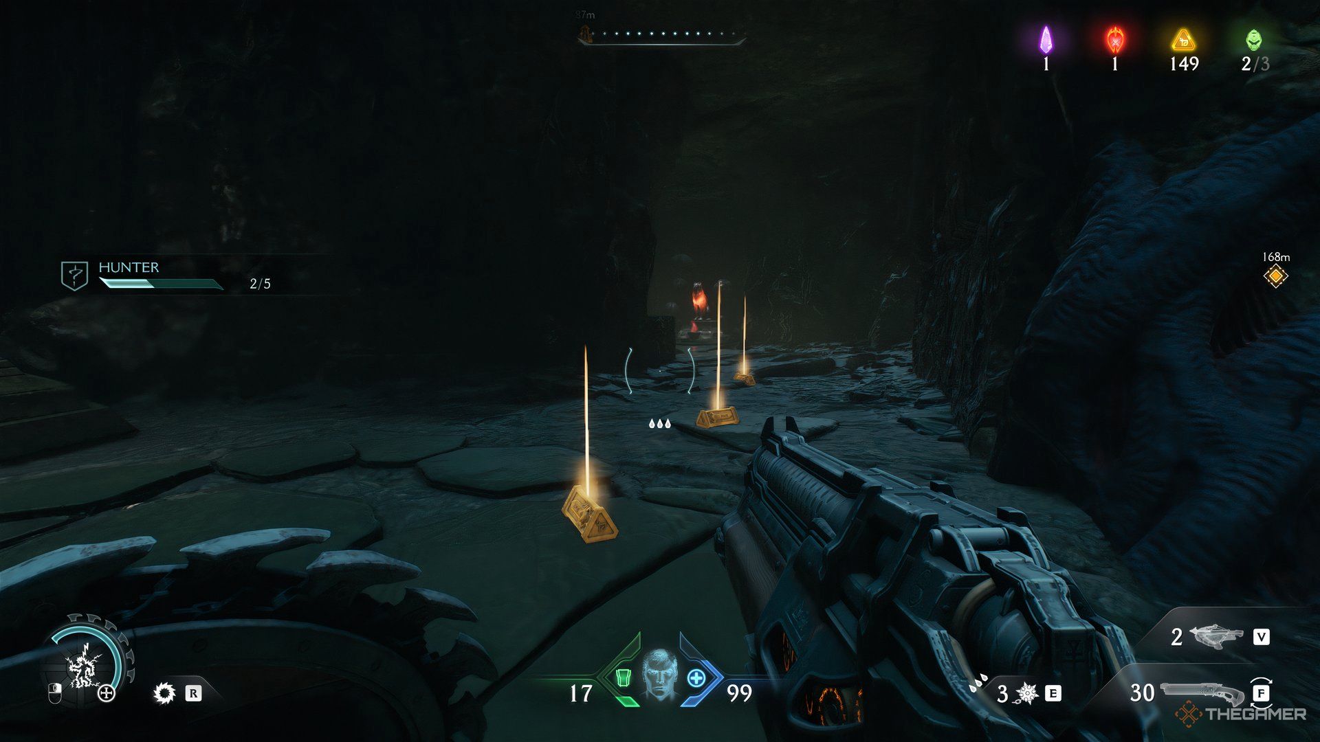 Doom Slayer walking into a tunnel with gold on the ground in Doom: The Dark Ages. There is a third Wolf Statue in the back.