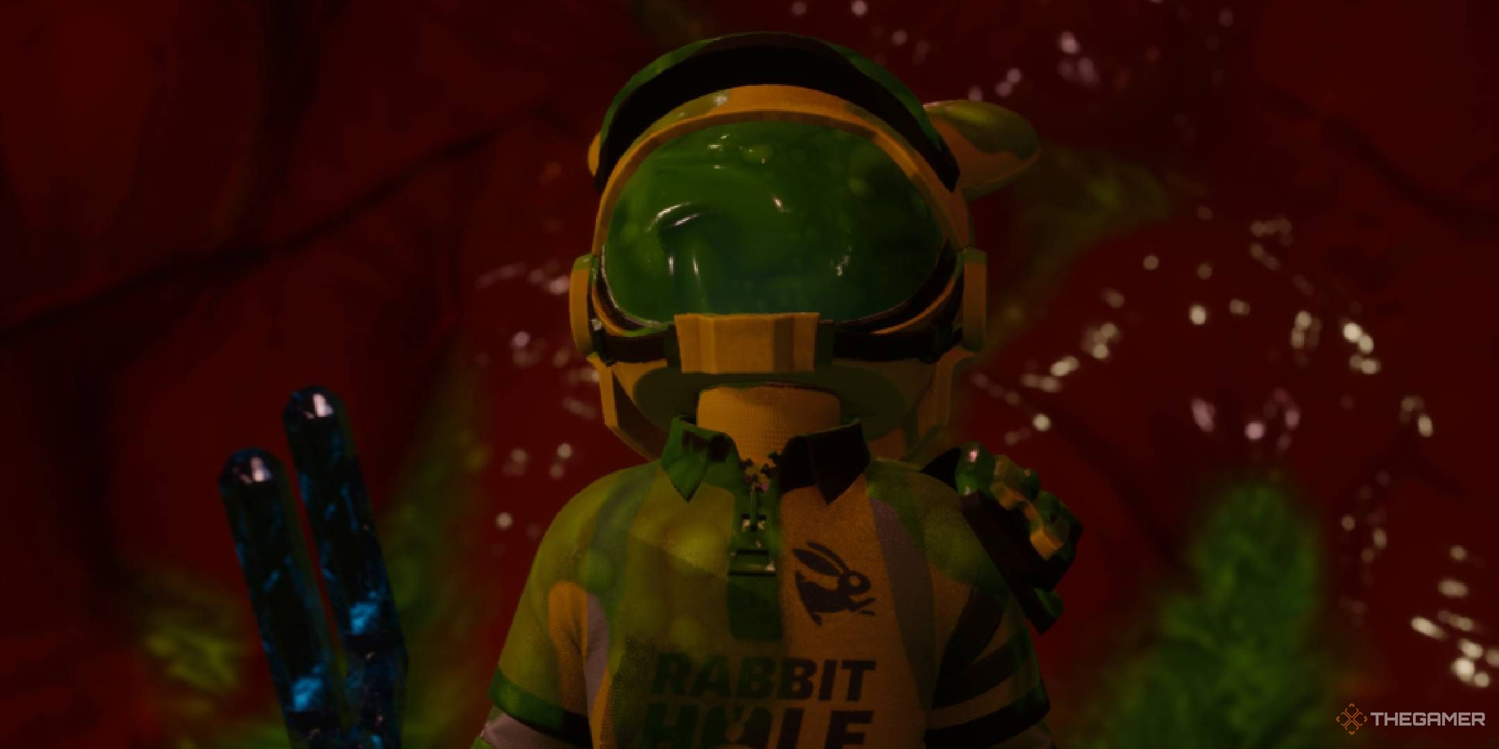 Revenge of the Savage Planet character holding the magnetic fork and covered in goo.