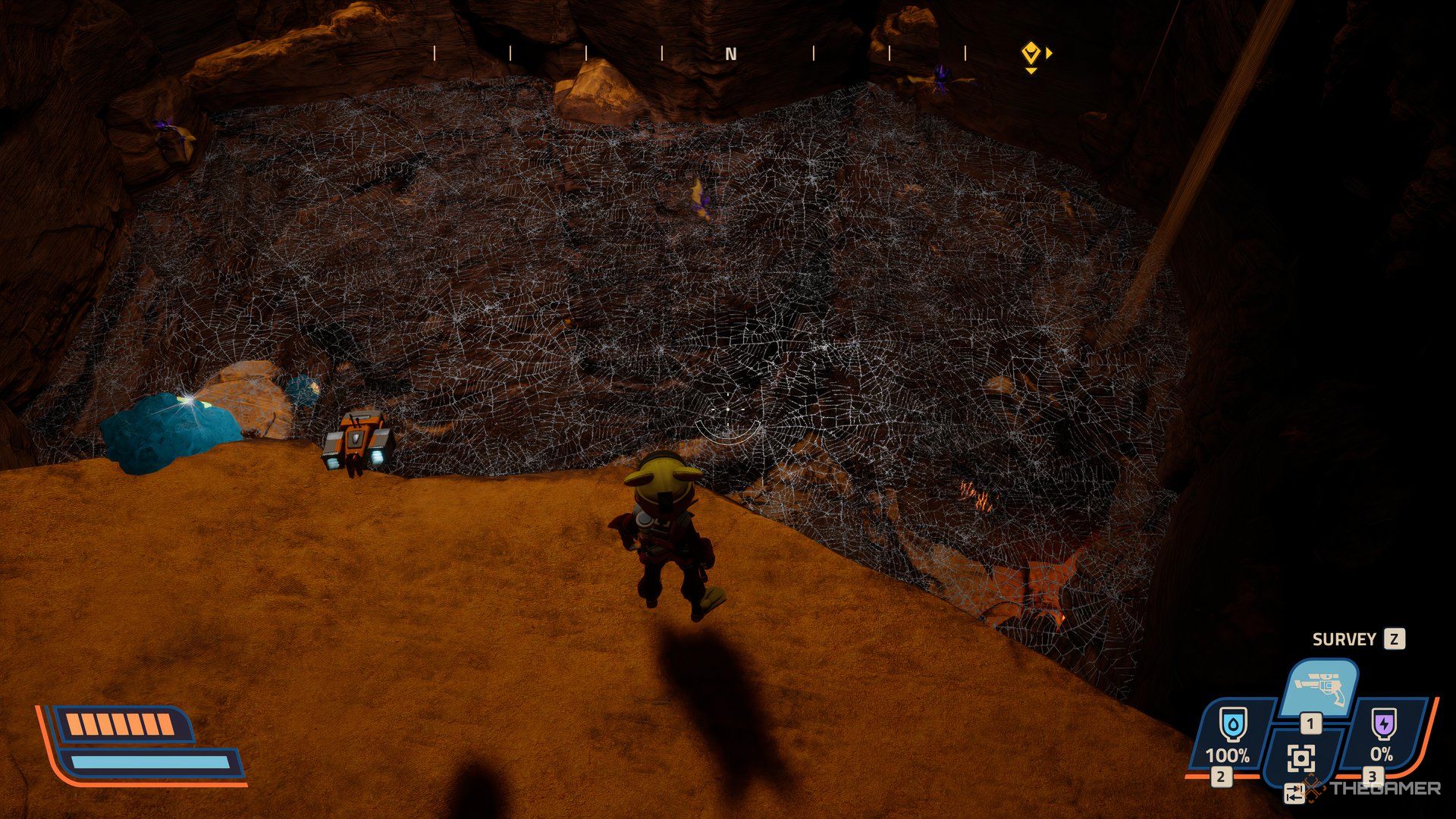 Player in a cave looking down at a large spider web blocking a passageway in Revenge of the Savage Planet.