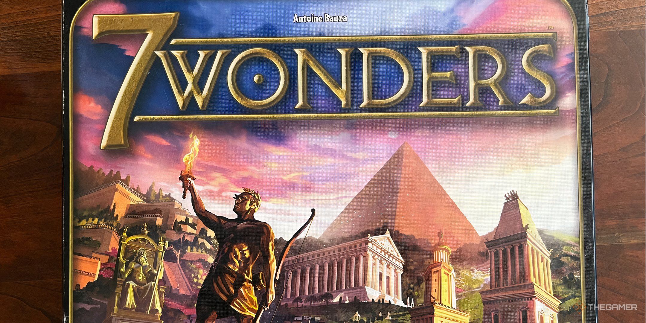 Seven wonders of box art with colossus and pyramids.