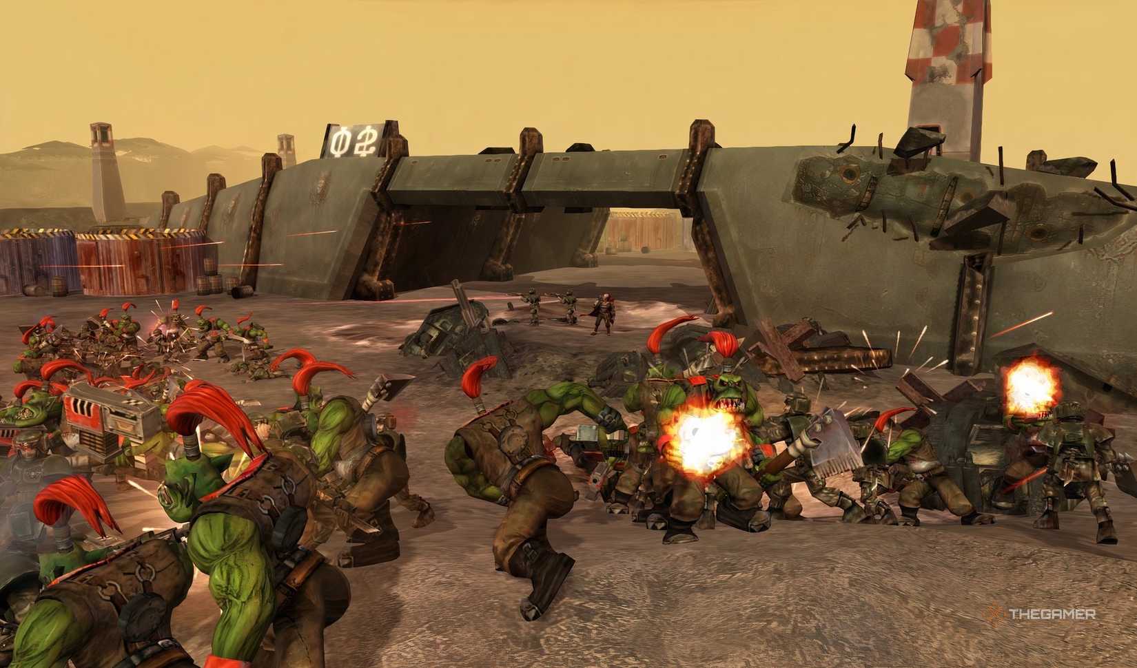 An army of Orcs fighting Humans on a battlefield in Warhammer 40K: Dawn of War - Definitive Edition.